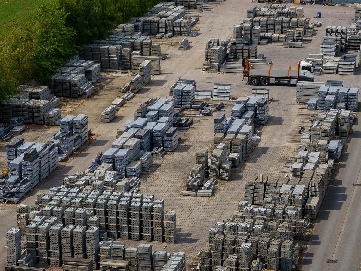 Palletized materiel staged in rows across a distribution yard, seen from above