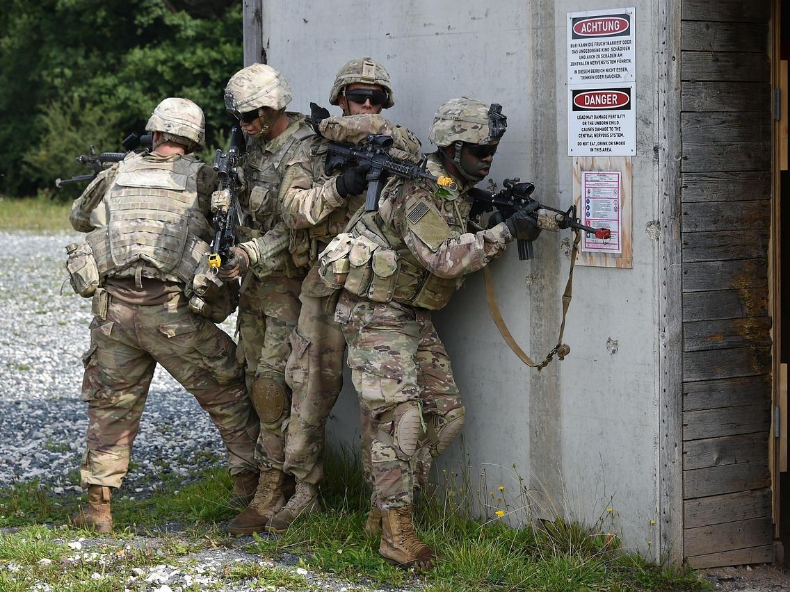A small unit stacked at an entry point during urban training